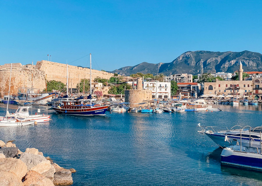 Boats and stone harbour walls beside the blue waters of Kyrenia
