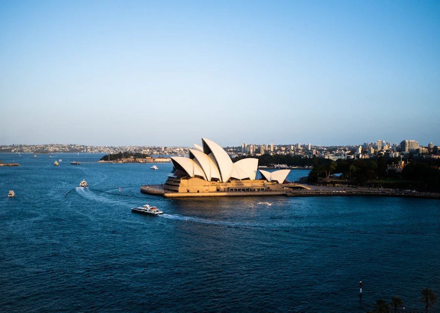 Sailboats passing Sydney Opera House and the waterfront