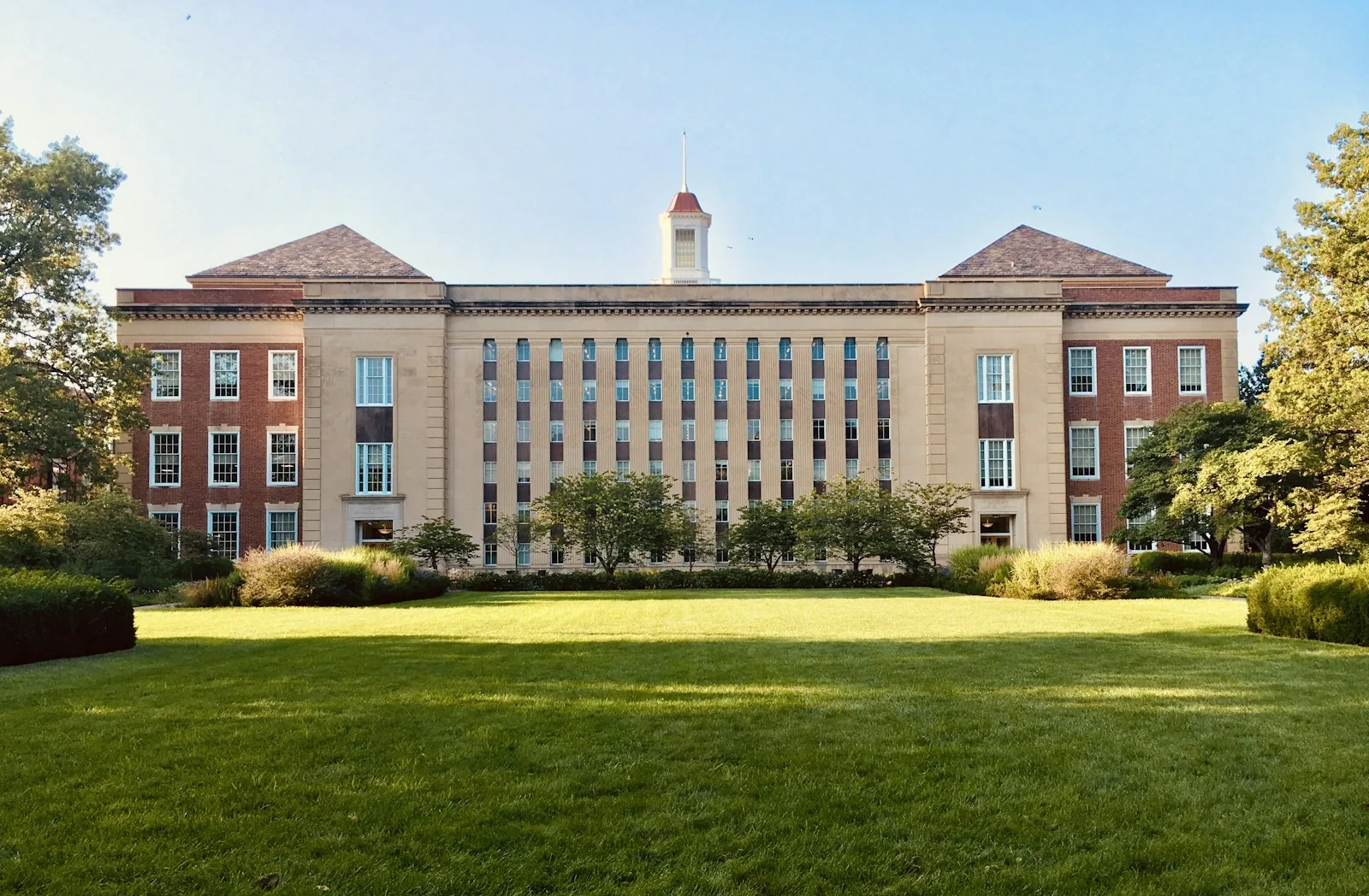 A brick campus building beyond a green lawn in Lincoln, Nebraska